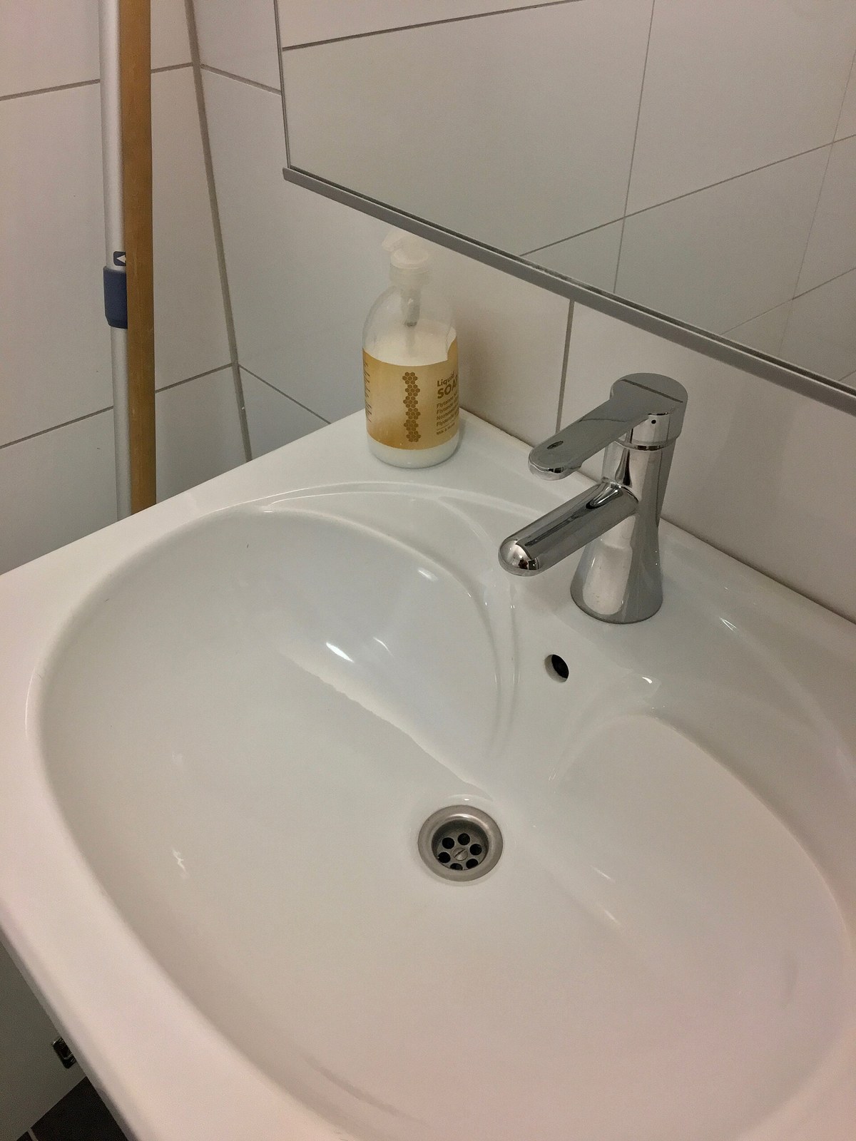 A chrome single-lever mixer tap on a white basin